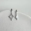 Exquisite asymmetrical star design earrings featuring a sleek liquid silver finish and unique geometric drop. - 2266 Asymmetric Stars