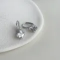 Closeup view of elegant square cubic zirconia huggie earrings with detailed micro pave sparkle. - 1654 Zirconia Ear Hoops