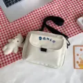 White nylon crossbody bag with black strap and cute front pocket, casual style for daily wear. - White + Bear