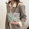 Detailed close-up view of a floral canvas cosmetic bag, portable toiletry pouch for travel. - Dreamy Jungle