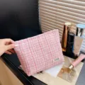 Pink tweed makeup bag detail showcasing soft texture, elegant cosmetic storage pouch for women. - Pink Tweed Style