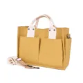 Canvas tote bag with double front pockets, yellow and cream color design, detail view. - Yellow