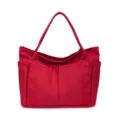 Red canvas tote bag detail, multi-pocket design, durable fabric, casual everyday shoulder bag. - Red