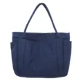 Dark blue canvas tote bag detail, featuring durable fabric, front pockets and double straps. - Dark Blue