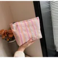 Detailed view of the striped bubble cosmetic bag showing texture and portable design. - Pink Striped