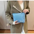 Casual light blue denim makeup bag clutch purse with front label, large capacity pouch. - Light Blue Denim