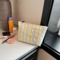 Striped cosmetic bag for women, large capacity makeup pouch, stylish striped travel organizer. - Yellow Colorful Stripes