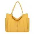 Detail view of yellow canvas tote bag showcasing front pockets and sturdy stitching structure. - Yellow