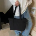 Black canvas tote bag, casual large capacity shoulder bag with multiple pockets for daily commute. - Black