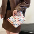 Quilted floral cosmetic bag, cute embroidered makeup pouch for daily travel and storage. - Orchid