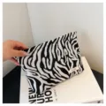 Detailed view of black and white zebra print canvas cosmetic pouch, compact portable storage bag. - White Zebra Pattern