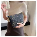Vintage black cosmetic bag with elegant gold butterfly embroidery for daily storage. - Black With Gold Butterflies