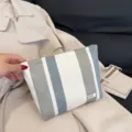 Striped linen cosmetic pouch variant, portable casual hand clutch bag in white and grey tones. - Gray