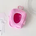 Close-up detail of the pink polka dot plush mini doll bag with heart window and cute keychain. - Rose Red