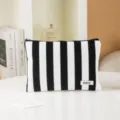 Detailed view of a black and white striped cosmetic bag showcasing clean stitching and durable zipper. - Black & White Stripes
