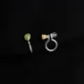 Detailed view of invisible non-pierced clip-on earrings with green stone and gold base. - Small Green Beans
