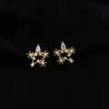 Close-up detail of exquisite gold star clip-on earrings sparkling with stunning cubic zirconia. - Non-pierced Spiral Clip-on Earrings / Zircon Star