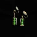 Golden clip-on earrings detailed view, featuring green beads inside a geometric frame. - Small Abacus Style