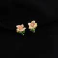 Elegant enamel flower clip-on earrings with green stems and sparkling crystal centers. - Morning Glory Style