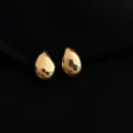 Close-up detail shot of smooth gold teardrop clip-on earrings showcasing polished finish. - Non-pierced Spiral Clip-on Earrings / Water Drop