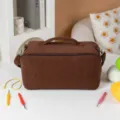 Bruine corduroy garen opbergtas detail met duurzame stoffen textuur, rits en handvat. - Donkerbruin