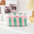 Detail view of colorful stripe PVC cosmetic bag, waterproof travel makeup pouch with handle. - Handheld Green and Pink