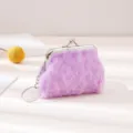 Close-up of a purple plush coin purse detail, featuring metallic kiss-lock and key ring. - Purple