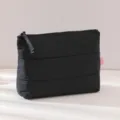 Black quilted makeup bag detail showing soft puffy cloud design and smooth zipper closure. - 25x17cm / Black
