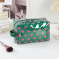 Green polka dot PVC cosmetic bag detail shot, waterproof travel zipper toiletry storage pouch. - Green Polka Dot