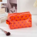 Orange PVC polka dot cosmetic bag, waterproof zipper makeup organizer for travel and daily use. - Polka Dot Orange