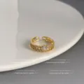 Eleganter goldener offener Ring mit Zirkonia-Steinen und Herz-Detail, minimalistischer Stil. - Offen Verstelbar / Hohlherz-Stil (Dick echtvergoldet)