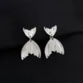 Silver fish tail earrings detail close-up, elegant alloy jewelry design showcase display. - Fishtail Ear Clip (W702)