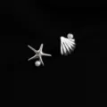 Close-up detail of silver starfish and seashell earrings with pearl embellishment. - Double Layer Clip-On Earrings / Seashell and Starfish