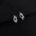 Close-up detail shot of elegant silver knot earrings on black background, premium jewelry texture. - Metal Knot Ear Clip (W1261)