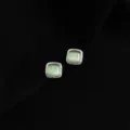Detail shot of elegant square green cat eye stone stud earrings with polished metal border. - Double Layer Clip-On Earrings / Glass Cat's Eye Stone