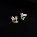 Detail shot of tulip clip-on earrings with pink enamel and pearl accent on black background. - Double Layer Clip-On Earrings / Tulip