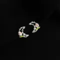 Detailed shot of silver-tone crescent moon tulip pearl earrings with enamel and rhinestones. - Double Layer Clip-On Earrings / Moon Tulip