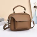 Brown soft leather women crossbody bag detail, multi-compartment design with metal hardware. - Brown
