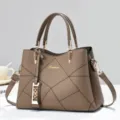 Brown textured leather handbag featuring geometric stitching, gold hardware and dual handles. - Khaki