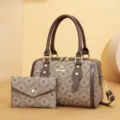 Detailed view of brown retro pillow handbag and wallet set with monogram pattern and top handles. - New A Coffee with Small Pouch