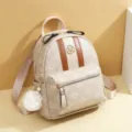 Elegant women's mini backpack with stylish vertical stripes and charm for daily travel. - Large Embossed Style / Milk Tea