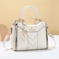 White women handbag stylish crossbody shoulder bag with golden hardware and chic pearl charm. - Stitched Off-white