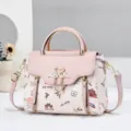 Chic pink and white women's handbag with top handle, shoulder strap, and cute printed pattern. - Pink