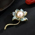Elegant lotus brooch featuring a freshwater pearl, blue enamel petals, and glittering crystals. - Blue