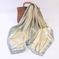 Detailed view of luxurious satin square scarf with elegant botanical line print draped gracefully. - 90x90cm / Ginkgo Pearl - Light Green