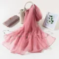 Detailed view of a solid pink ice silk chiffon scarf with delicate pearl chain decor. - Dusky Pink