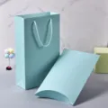 Light blue paper gift bag and pillow box set for clothing, scarf, and holiday packaging detail. - Light Blue Gift Box Set