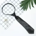 Detail view of a black pre-tied short tie, featuring smooth satin finish and convenient zipper. - Solid Navy Blue