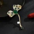 Elegant gold plated leaf brooch with green gemstones and pearl, perfect suit accessory. - Leaf Shape