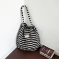 Retro black and white striped plush shoulder tote bag displayed in a cozy room corner - Black & White Stripes